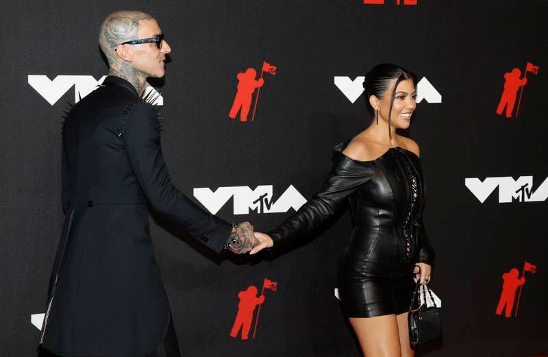 US musician Travis Barker and reality TV star Kourtney Kardashian, in Olivier Theyskens, arrive on the MTV Video Music Awards red carpet at the Barclays Centre in Brooklyn, New York on September 12, 2021. Photos: EPA