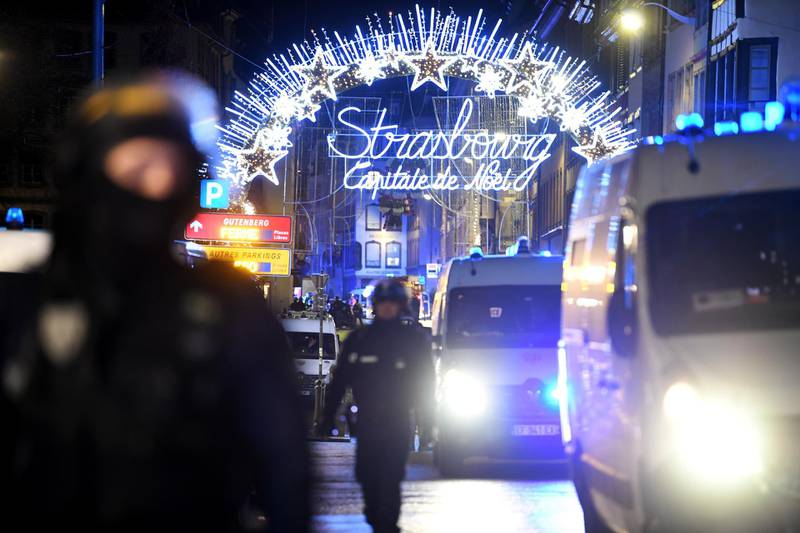 Police officers stand guard near the Christmas market where a deadly shooting took place in Strasbourg. EPA
