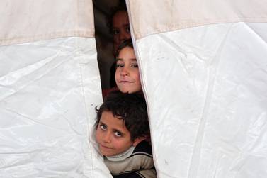 Displaced Syrian children who fled from southern Idlib look through a tent in Afrin, Syria February 7, 2020. REUTERS/Khalil Ashawi