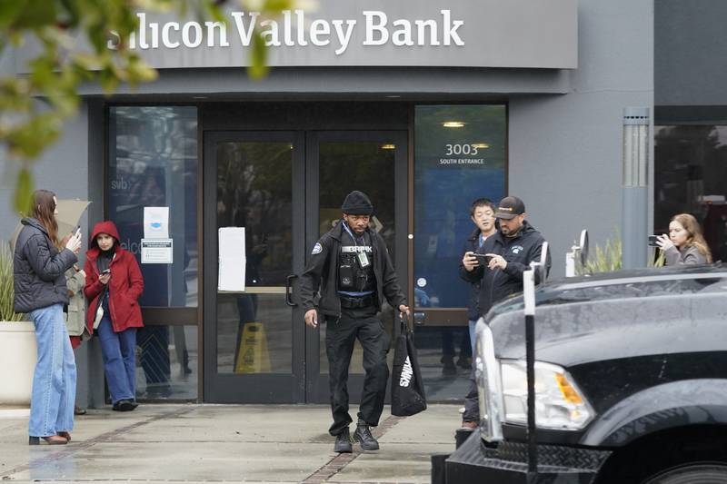 A Brinks worker after leaving Silicon Valley Bank in Santa Clara, California on Friday. The US rushed to seize the assets of SVB after a run on the bank. AP