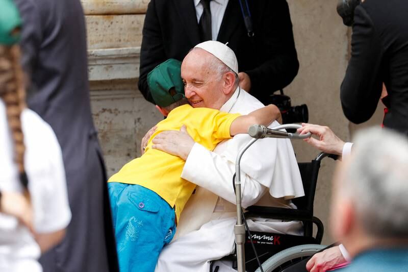 Pope Francis hugs a child during a meeting at the Vatican with children with disabilities and Ukrainian children who fled their country. Reuters