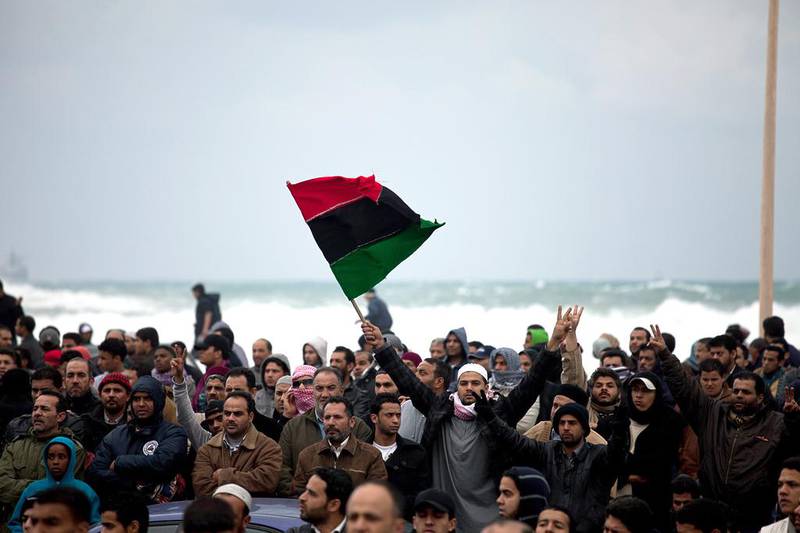 A protester waves the former Libyan  flag during a demonstration in 2011 in Benghazi. (Trevor Snapp / AFP)