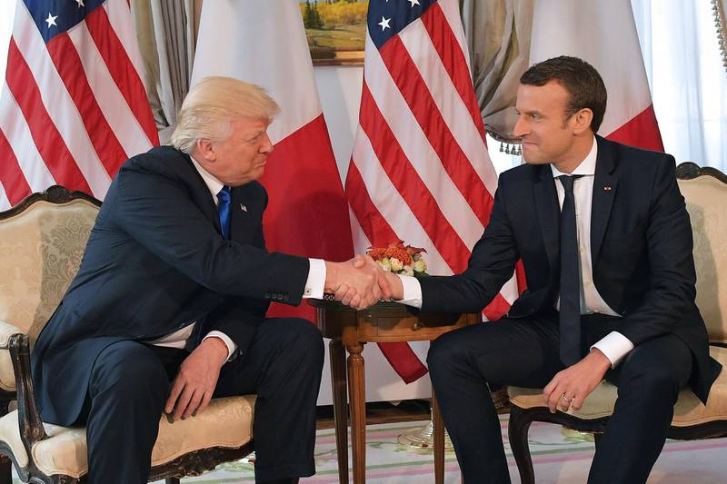 (FILES) In this file photo taken on May 25, 2017 US President Donald Trump (L) and French President Emmanuel Macron (R) shake hands ahead of a working lunch, at the US ambassador's residence, on the sidelines of the NATO (North Atlantic Treaty Organization) summit, in Brussels.
France will mark one year since the election of Emmanuel Macron as French President on May 7, 2018. / AFP PHOTO / Mandel NGAN