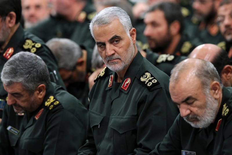 FILE- In this Sept. 18, 2016 photo released by an official website of the office of the Iranian supreme leader, Revolutionary Guard Gen. Qassem Soleimani, center, attends a meeting with Supreme Leader Ayatollah Ali Khamenei and Revolutionary Guard commanders in Tehran, Iran. Iran's paramilitary Revolutionary Guard faces new sanctions from U.S. President Donald Trump as he has declined to re-certify the nuclear deal between Tehran and world powers. But what is this organization? (Office of the Iranian Supreme Leader via AP, File)
