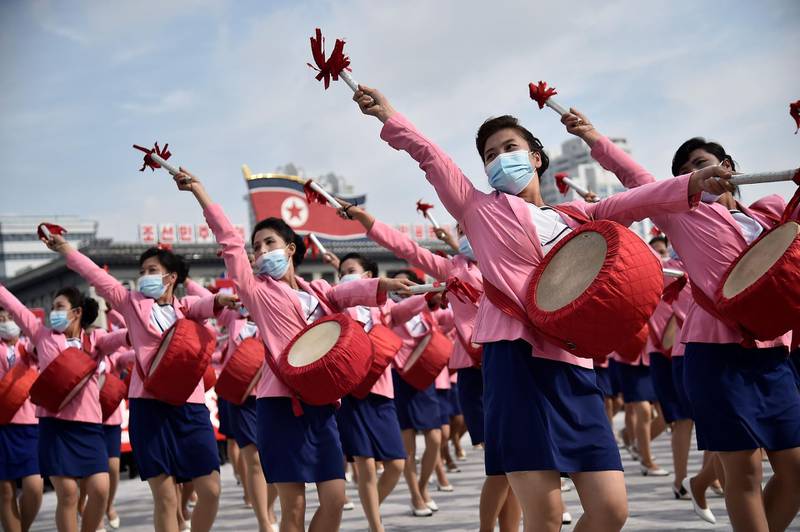 Participants wearing masks attend a rally marking the start of an '80-day Campaign' in support of the upcoming 8th Congress of the Workers' Party of Korea (WPK) to be held in January at Kim Il Sung Square in Pyongyang. AFP