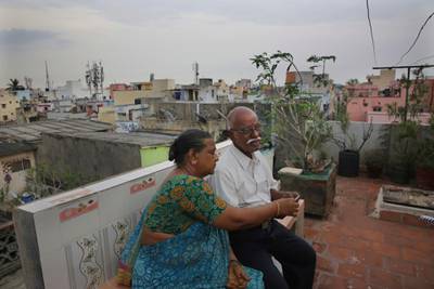 Retired Indian civil servant R. Devarajan with his wife Padmini sit at the terrace of their house equipped with rain water harvesting system in Chennai, India. AP