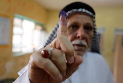 An Iraqi man shows his ink-stained finger after casting his vote at a polling station during the parliamentary election in the Sadr city district of Baghdad, Iraq May 12, 2018. REUTERS/Wissm al-Okili