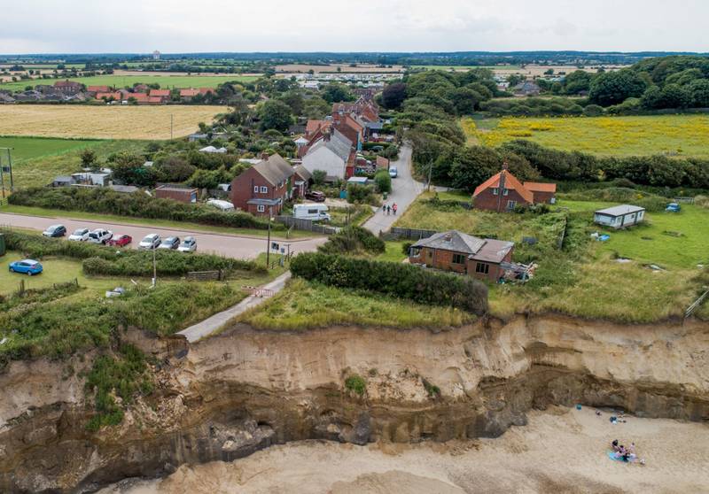The UK's Environment Agency says more villages, like Happisburgh, face being lost to the sea because of coastal erosion. Bloomberg