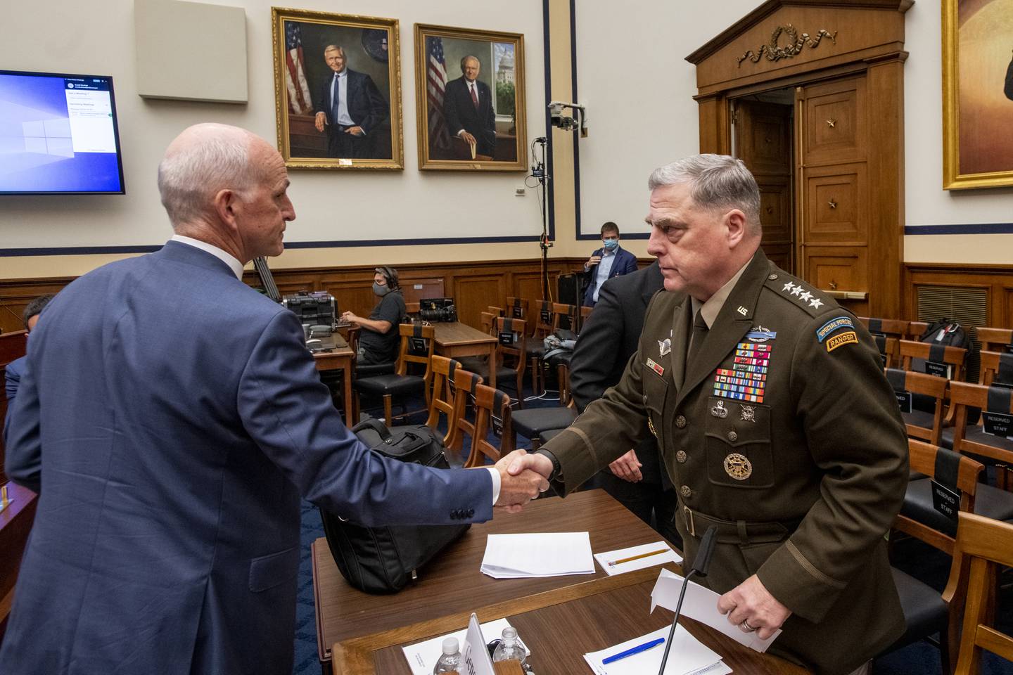 Adam Smith greets Chairman of the Joint Chiefs Gen Mark Milley after a House armed services committee hearing on Afghanistan. AP