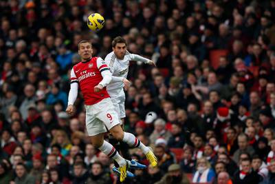 Arsenal's Lukas Podolski (L) challenges Swansea's Angel Rangel during their English Premier League soccer match at the Emirates stadium in London December 1, 2012. REUTERS/Stefan Wermuth (BRITAIN - Tags: SPORT SOCCER) NO USE WITH UNAUTHORIZED AUDIO, VIDEO, DATA, FIXTURE LISTS, CLUB/LEAGUE LOGOS OR "LIVE" SERVICES. ONLINE IN-MATCH USE LIMITED TO 45 IMAGES, NO VIDEO EMULATION. NO USE IN BETTING, GAMES OR SINGLE CLUB/LEAGUE/PLAYER PUBLICATIONS. FOR EDITORIAL USE ONLY. NOT FOR SALE FOR MARKETING OR ADVERTISING CAMPAIGNS *** Local Caption ***  SWT03_SOCCER-ENGLAN_1201_11.JPG