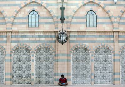Sharjah, United Arab Emirates - February 27th, 2018: Stand alone. A man waits outside the Sharjah Islamic Museum. Tuesday, February 27th, 2018. Sharjah. Chris Whiteoak / The National