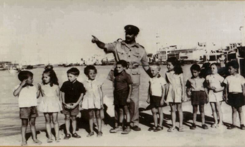 Flight Lt F Loughman and the founding class of Dubai English Speaking School in the area where the dry docks are now.