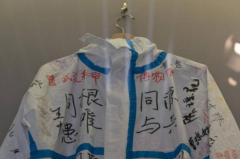 A hazmat suit signed and donated by a Hainan medical team that supported Hubei province during lockdown, displayed in a room of the Wuhan Revolution exhibition, in Wuhan.  AFP