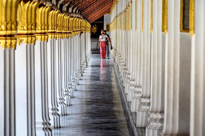 Tourists visit the reopened Grand Palace in Bangkok. AFP