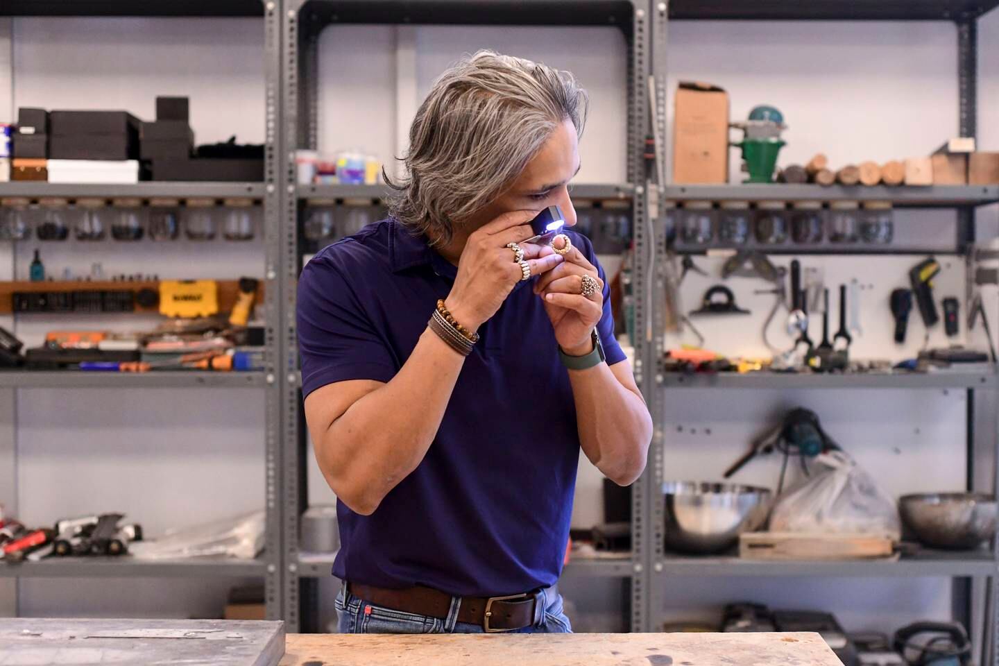 Riaz observes every detail through the jewellers loupe to check the quality of work produced at his studio space in Mussafah, Abu Dhabi. Khushnum Bhandari / The National
