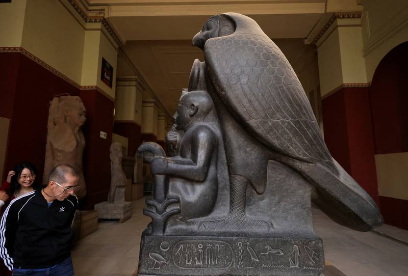 Tourists examine a statue of Ramses II and Horus at the Egyptian Museum in Cairo, Egypt. Reuters