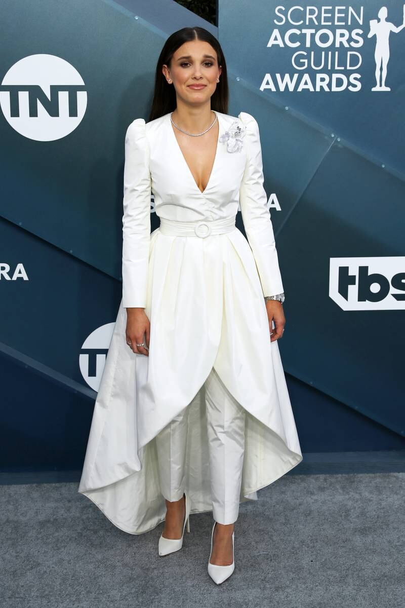 Millie Bobby Brown, wearing a white Louis Vuitton coat dress and trousers, attends the Screen Actors Guild Awards in Los Angeles on January 19, 2020. EPA