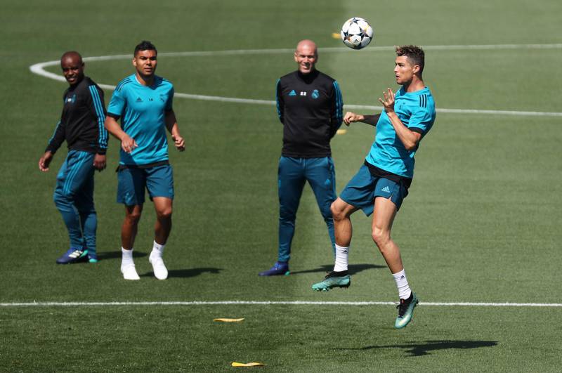Real Madrid forward Cristiano Ronaldo heads the ball in training as Zinedine Zidane looks on. Sergio Perez / Reuters