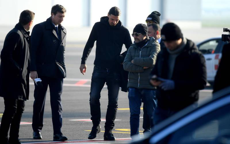 New AC Milan forward Zlatan Ibrahimovic is welcomed by officials. AFP