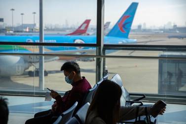 Travellers sit at a boarding gate at the Shanghai Hongqiao International Airport. Only a third of passengers have taken a commercial flight since the pandemic began, a figure that rises to almost half for UAE fliers, according to Inmarsat's Passenger Confidence Tracker. Associated Press
