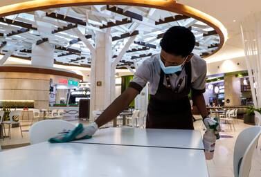 Abu Dhabi, United Arab Emirates, August 19, 2020. Yas Mall cleaners at the food court. Victor Besa /The National Section: NA Reporter: Haneen Dajani