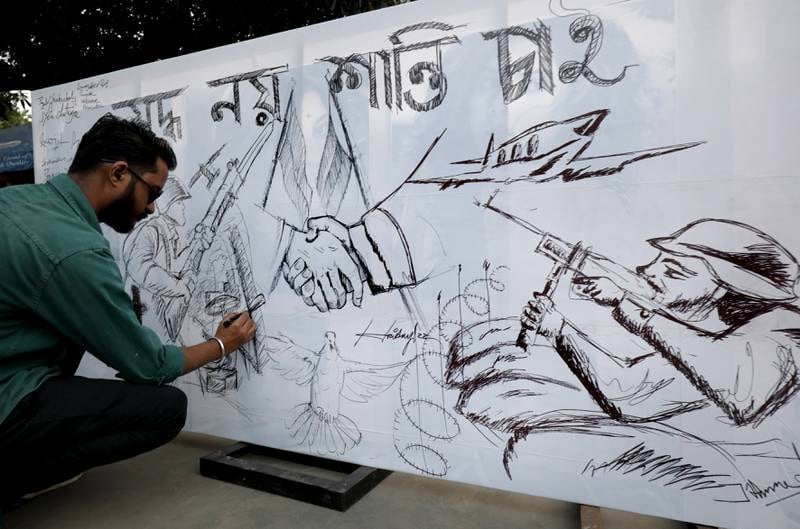 An Indian artist draws a poster during a protest in Kolkata. EPA