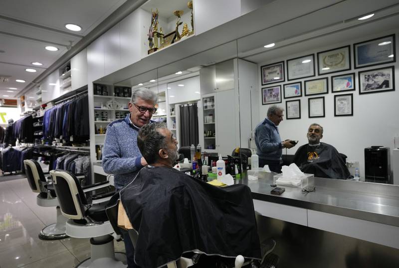Elie Rbeiz, 70, a hairdresser at his shop in Hamra Street. Mr Rbeiz expanded his business 20 years ago to include men clothes. "Hamra is not the Hamra of the past," he said. His business has dropped 60% over the past two years.