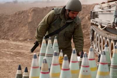 An Israeli artillery soldier checks shells at an area along the border with Gaza as Israel prepares for a potential ground invasion. EPA