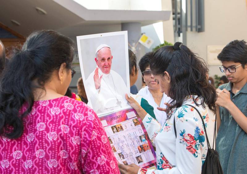 DUBAI, UNITED ARAB EMIRATES -Faithfuls checking out the calendars with Pope Francis image at St. Mary's Catholic Church, Oud Mehta.  Leslie Pableo for The National for Anam Rizvi's story