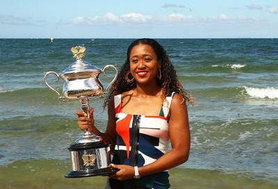 MELBOURNE, AUSTRALIA - JANUARY 27:  Naomi Osaka of Japan poses with the Daphne Akhurst Memorial Cup during the Women's Australian Open media opportunity at Brighton Beach on January 27, 2019 in Melbourne, Australia. (Photo by Julian Finney/Getty Images)