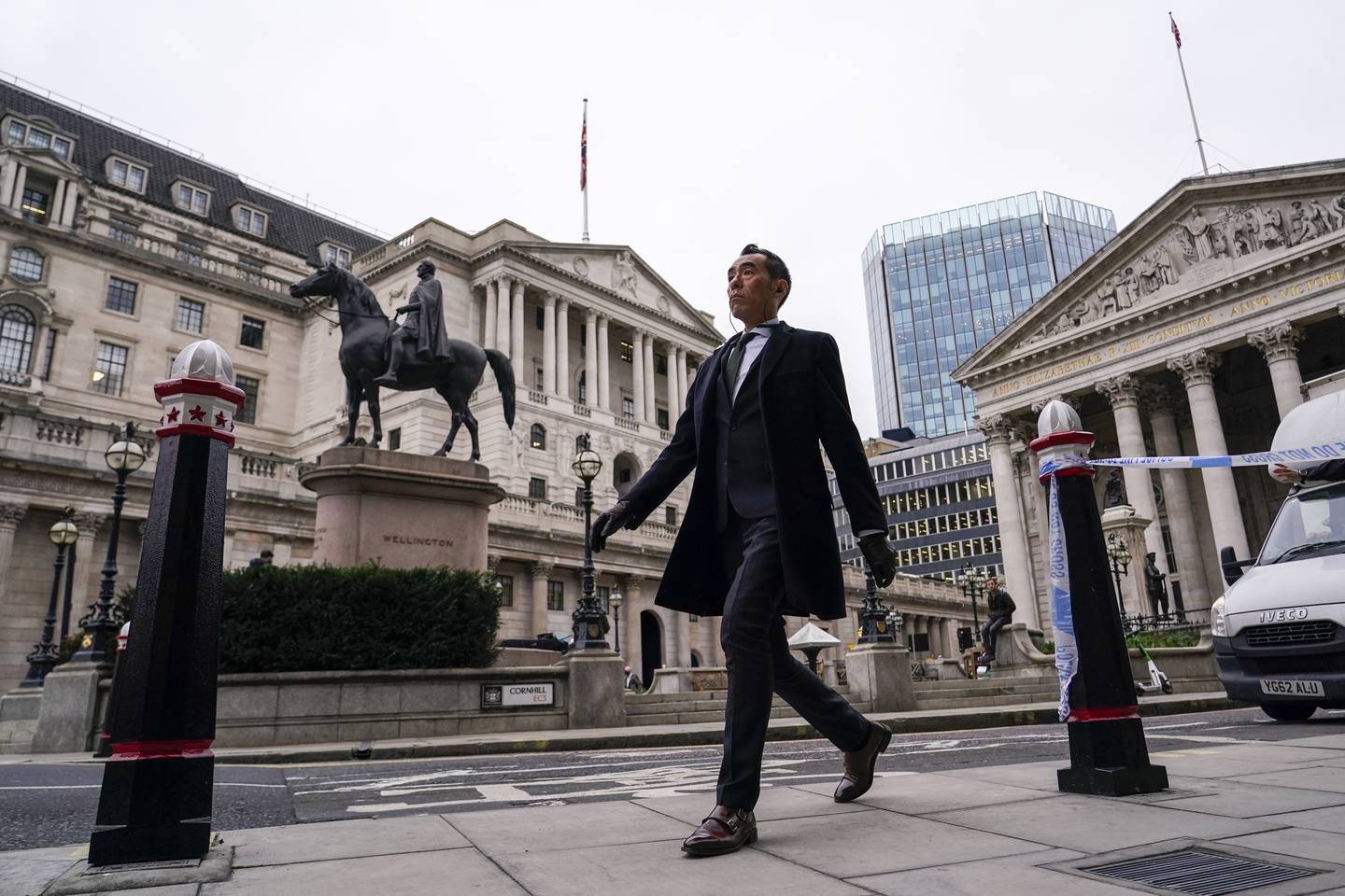 A man walks outside the Bank of England. The central bank raised interest rates for the first time since the pandemic started in December. AP