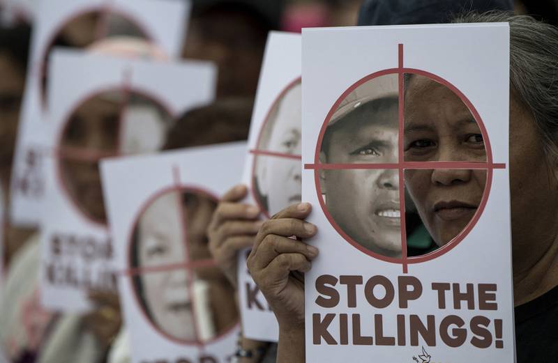Activists hold placards in Manila as they commemorate International Human Rights Day in 2017. Philippine President Rodrigo Duterte rejected accusations of rights abuses during his term in a drug war that killed thousands of people. AFP