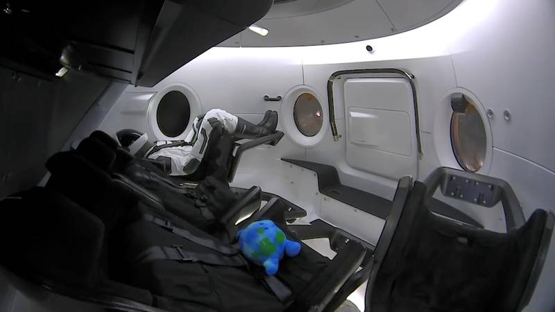 A life-size test mannequin and a stuffed toy are seen inside the capsule as it launches into orbit en route to the International Space Station, arriving 27 hours after take-off.  AP