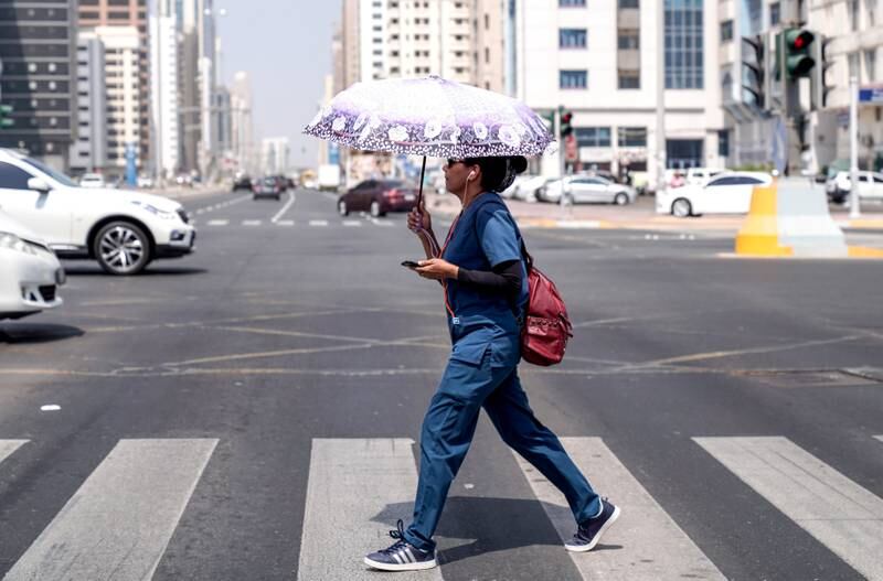 Abu Dhabi, United Arab Emirates, October 2, 2019, 2019.    Standalone images, Abu Dhabi. --  A woman crosses a street on downtown Abu Dhabi on a cool and sunny day.Victor Besa / The NationalSection:  NAReporter: