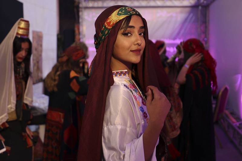A Palestinian woman, wearing a traditional embroidered dress, attends an event celebrating the registration of Palestinian embroidery on the Unesco Cultural Heritage List, in the West Bank city of Ramallah. AFP