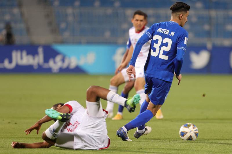 Hilal defender Muteb al-Mufarrij dribbles past Sharjah midfielder Majid Rashid.