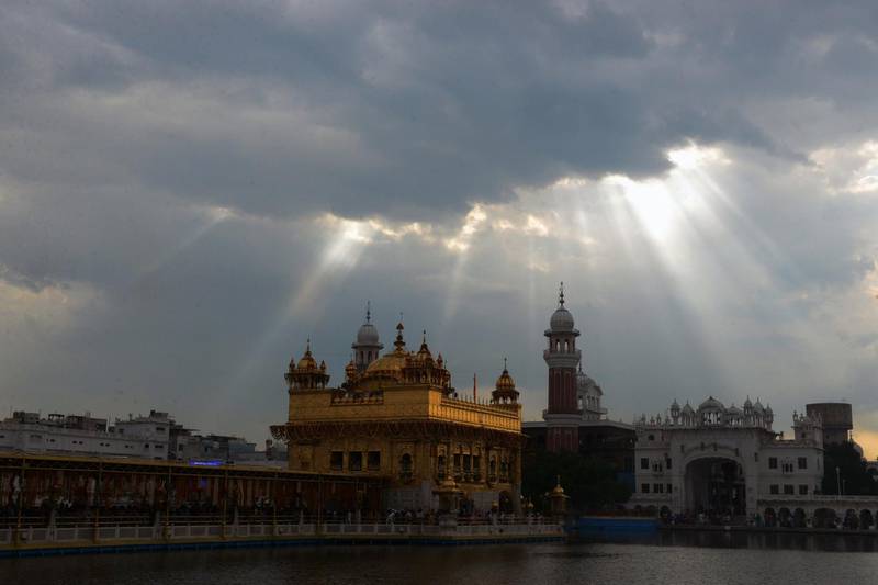 TOPSHOT - The Sikh Golden Temple is pictured under dark clouds in Amritsar on September 11, 2018. (Photo by NARINDER NANU / AFP)
