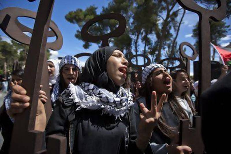 Palestinian girls hold up wooden replicas of keys, symbolising their displacement from their homes, as Palestinians mark Yawm Al Nakba in the West Bank town of Ramallah.