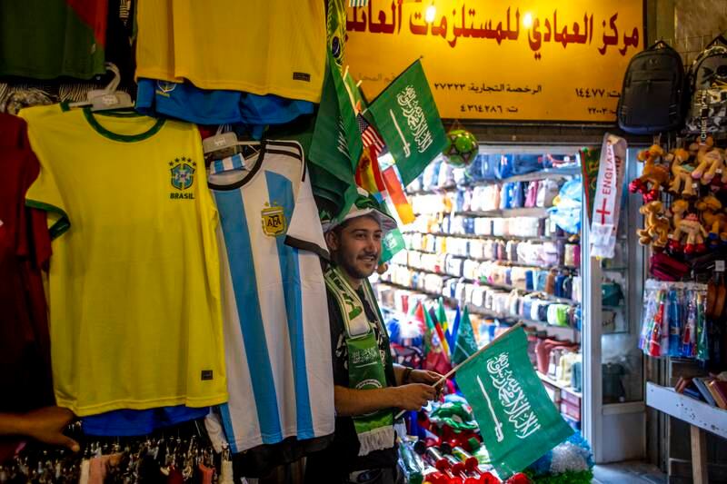 A stallholder in the Souq Waqif market area selling World Cup paraphernalia during the Fifa World Cup 2022 in Qatar. EPA