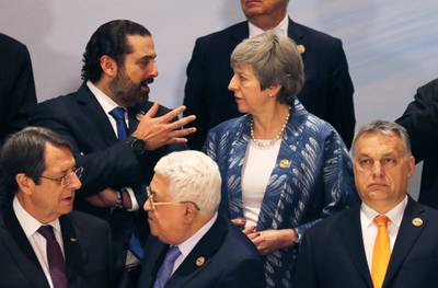 Britain's Prime Minister Theresa May and Lebanese Prime Minister Saad Al Hariri in discussion during the family photo. Reuters