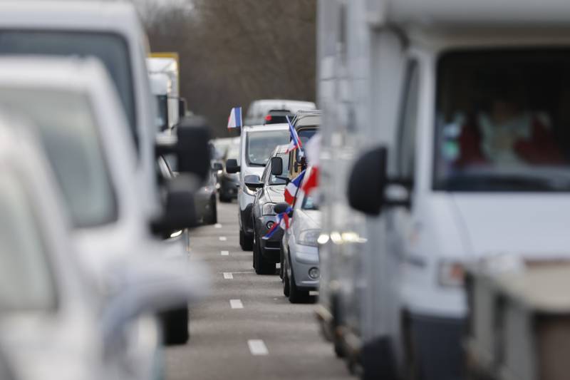 French flags are placed on cars that are part of a convoy heading to Paris from Strasbourg. AP Photo