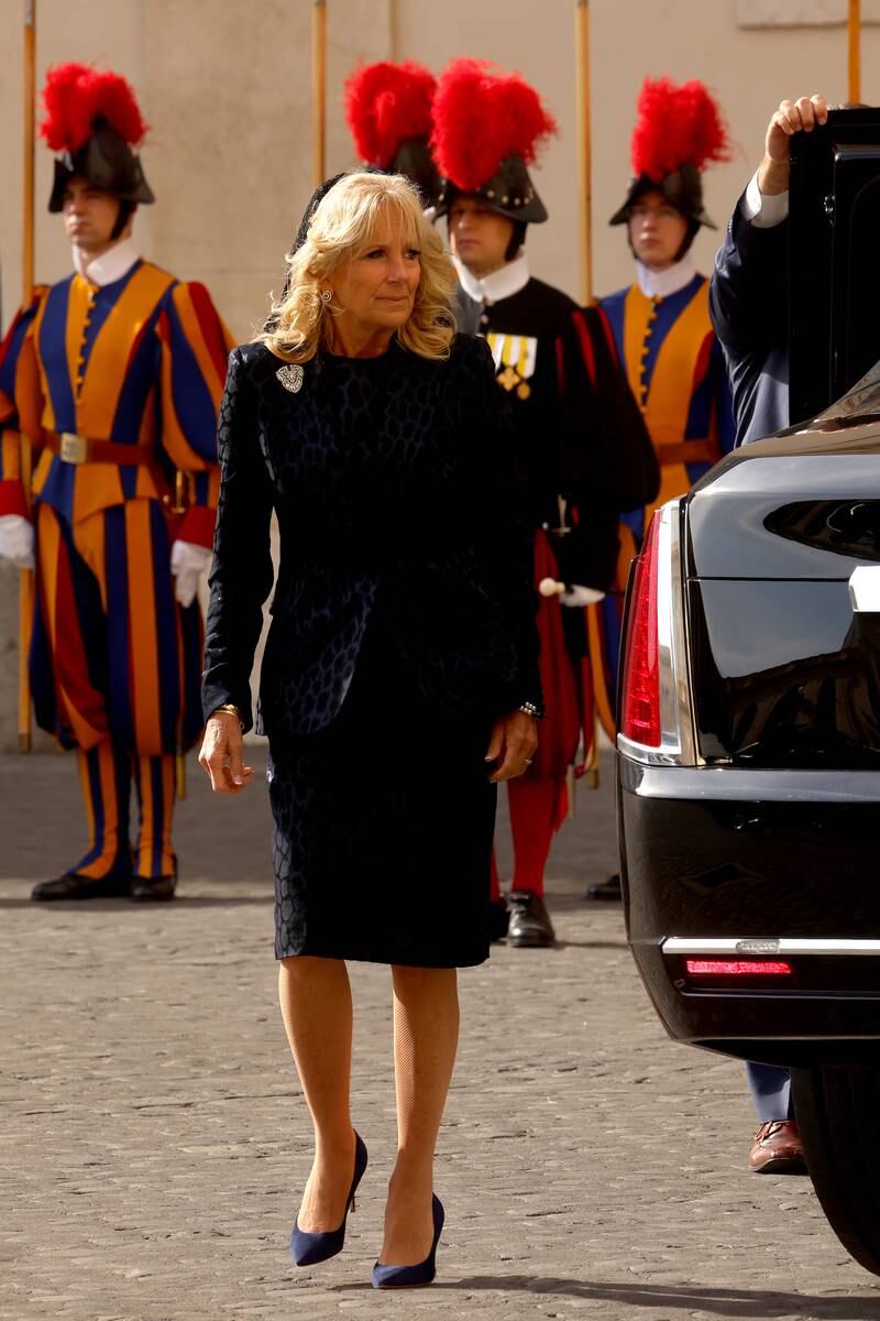 Jill Biden, wearing a matching navy dress and blazer, arrives at the San Damaso Courtyard for a meeting with Pope Francis on October 29, 2021 in Vatican City. Getty Images