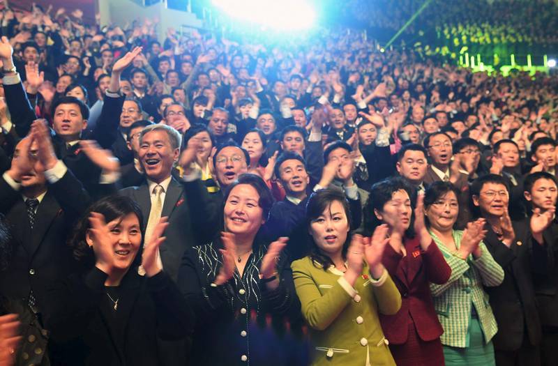 North Koreans react as they watch a joint performance by South and North Korean musicians. AFP / Korea Pool