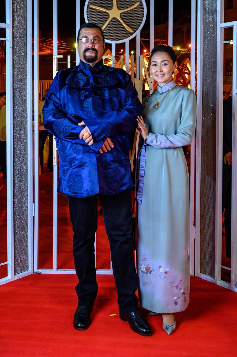 US actor Steven Seagal poses with his wife Erdenetuya on the red carpet during the closing ceremony of the El Gouna Film Festival. AFP
