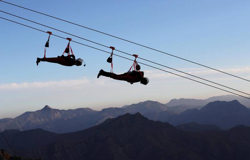 People ride the world's longest zip-line over Ras al-Khamiah's Jabal Jais Mountain, UAE January 31, 2018. Picture taken January 31, 2018. REUTERS/Ahmed Jadallah     TPX IMAGES OF THE DAY