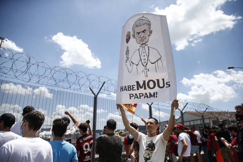 Supporters wait for the arrival of new Roma coach Jose Mourinho.