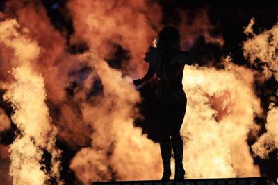 Gaga commanded a large troupe of dancers and musicians, props that breathed fire and audience members swinging lights in synchronisation — the usual excess that has become a Super Bowl cliche.  Tannen Maury / EPA
