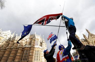 Pro-Europe demonstrators hang British and EU flags during a protest outside parliament. AP.