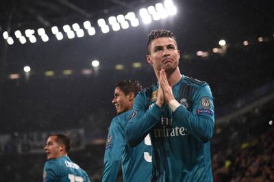TOPSHOT - Real Madrid's Portuguese forward Cristiano Ronaldo (R) celebrates after scoring a second goal during the UEFA Champions League quarter-final first leg football match between Juventus and Real Madrid at the Allianz Stadium in Turin on April 3, 2018. / AFP PHOTO / Marco BERTORELLO