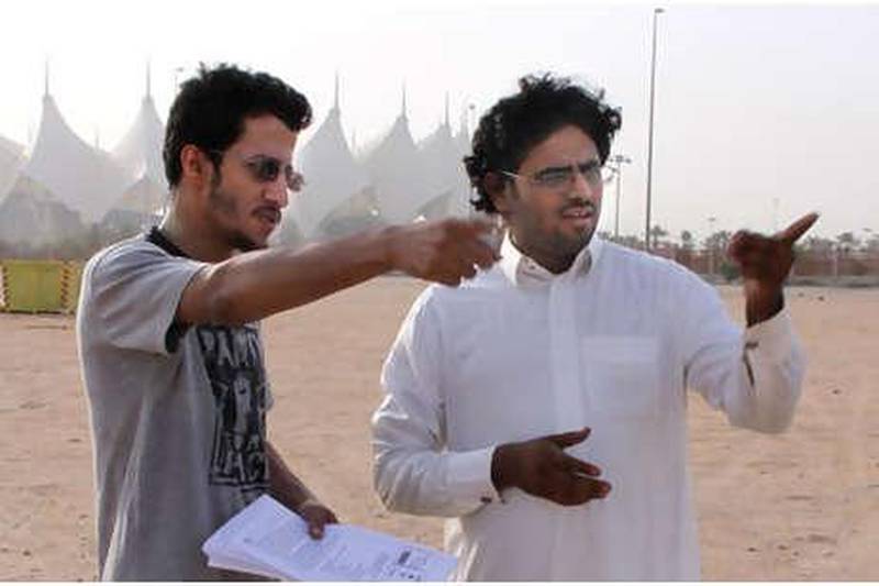 The Saudi film-maker Abdulmuhsen al Mutairi, left, with his lead actor, Ali al Bahlol, filming a scene for al Mutairi's new short film, A Man Between Two Gangs and a Grave.